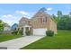 Traditional two-story home featuring a brick facade, attached garage, and a green lawn at 6533 Waterford Sw St, Atlanta, GA 30331