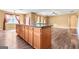 Spacious kitchen island with dark countertops and wood cabinets in an open concept kitchen and living area at 6533 Waterford Sw St, Atlanta, GA 30331