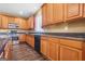 Well-lit kitchen features wooden cabinets, stainless steel appliances, granite countertops, and modern flooring at 6533 Waterford Sw St, Atlanta, GA 30331
