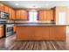 The kitchen features a central island, wooden cabinetry, stainless steel appliances, and modern flooring at 6533 Waterford Sw St, Atlanta, GA 30331
