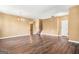 Spacious living area with dark hardwood floors, neutral paint, a chandelier and staircase at 6533 Waterford Sw St, Atlanta, GA 30331