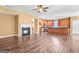 Open-concept living room featuring hardwood floors, fireplace, and a view into the modern kitchen at 6533 Waterford Sw St, Atlanta, GA 30331