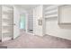 Bright walk-in closet with built-in shelving and a carpeted floor at 6533 Waterford Sw St, Atlanta, GA 30331