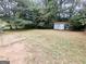 Backyard featuring a storage shed, patio, and mature trees at 578 Lakeridge Se Cir, Conyers, GA 30094