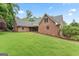 Brick home with well-manicured lawn featuring a screened-in porch and mature trees at 510 Jenna Trl, Mcdonough, GA 30252