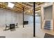 Unfinished basement featuring high ceilings, support columns, and stairs to the main level at 510 Jenna Trl, Mcdonough, GA 30252