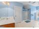 Bright bathroom with a glass-enclosed shower, vanity, and blue accents on the walls and floor at 510 Jenna Trl, Mcdonough, GA 30252