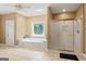 Bathroom featuring a soaking tub, glass door shower and tiled floor at 510 Jenna Trl, Mcdonough, GA 30252