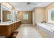 Bathroom featuring double vanity, soaking tub, tile floor, and ample counter space at 510 Jenna Trl, Mcdonough, GA 30252