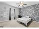 Bright bedroom with unique gray and white geometric accent wall and neutral carpet at 510 Jenna Trl, Mcdonough, GA 30252