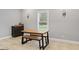 Simple dining area featuring wood picnic-style table with wood benches, tile flooring, and natural light at 510 Jenna Trl, Mcdonough, GA 30252