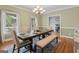 Elegant dining room featuring a wooden table and upholstered chairs, with natural light streaming through the windows at 510 Jenna Trl, Mcdonough, GA 30252