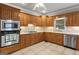 Traditional kitchen features oak cabinetry, tile backsplash, stainless steel appliances and tile floors at 510 Jenna Trl, Mcdonough, GA 30252