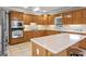 Well-equipped kitchen featuring oak cabinets, a center island, and modern appliances for culinary enthusiasts at 510 Jenna Trl, Mcdonough, GA 30252