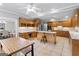 Expansive kitchen with oak cabinets, island with seating, adjacent dining area and tile floors at 510 Jenna Trl, Mcdonough, GA 30252