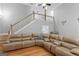 Spacious living room featuring a leather sectional sofa, hardwood floors, and staircase at 510 Jenna Trl, Mcdonough, GA 30252