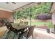 Screened in porch with outdoor dining area and view of lush, green backyard at 510 Jenna Trl, Mcdonough, GA 30252