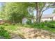 Secluded backyard featuring a storage shed, mature trees, natural stone path, and green grass at 2340 Landrum Ct, Lawrenceville, GA 30043