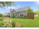 A backyard with green grass, mature landscaping, light gray siding, and stepping stone path at 2340 Landrum Ct, Lawrenceville, GA 30043