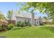 A well-maintained backyard with green grass, mature landscaping, wooden fence, and light gray siding at 2340 Landrum Ct, Lawrenceville, GA 30043