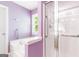 Bright bathroom featuring a white bathtub and a shower separated by glass doors at 2340 Landrum Ct, Lawrenceville, GA 30043