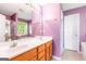 Bright bathroom featuring double sink vanity, large mirror, and combination shower and tub at 2340 Landrum Ct, Lawrenceville, GA 30043