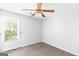 Bedroom features a ceiling fan, a window, and a closet at 2340 Landrum Ct, Lawrenceville, GA 30043