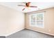 Neutral bedroom with a window, ceiling fan and neutral carpet at 2340 Landrum Ct, Lawrenceville, GA 30043