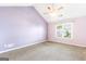 Bright bedroom with a vaulted ceiling, ceiling fan, and natural light from the window at 2340 Landrum Ct, Lawrenceville, GA 30043