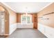 Elegant dining room featuring wainscotting, a chandelier, and natural light at 2340 Landrum Ct, Lawrenceville, GA 30043