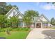 Charming home with a lush green lawn, mature trees, and a long driveway at 2340 Landrum Ct, Lawrenceville, GA 30043
