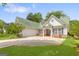 Inviting home features a two-car garage and a well-manicured lawn at 2340 Landrum Ct, Lawrenceville, GA 30043
