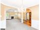 Spacious living room featuring a fireplace, chandelier, and archway detailing at 2340 Landrum Ct, Lawrenceville, GA 30043
