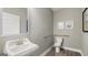 Clean, modern bathroom with pedestal sink, sleek fixtures, and handicap bars at 1739 Goodwin, Hampton, GA 30228