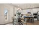 Bright dining area with table and chairs, open to the kitchen featuring white cabinetry at 1739 Goodwin, Hampton, GA 30228