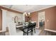 Elegant dining room with coffered ceilings, modern chandelier and stylish furnishings at 1739 Goodwin, Hampton, GA 30228