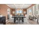 Open dining room features an elegant light fixture, hardwood floors, lots of natural light, and an adjacent living room at 1739 Goodwin, Hampton, GA 30228