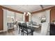 Formal dining area boasts an elegant light fixture, neutral paint, hardwood floors, and adjacent living spaces at 1739 Goodwin, Hampton, GA 30228