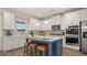 Beautiful kitchen features white cabinets, stainless steel appliances, a blue island, and a breakfast bar with seating at 1739 Goodwin, Hampton, GA 30228