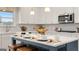 Bright kitchen features a large island with seating, stainless steel appliances, and modern white cabinetry at 1739 Goodwin, Hampton, GA 30228