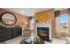 Cozy living room features a fireplace, tan walls, a round mirror, unique artwork, and lots of natural light at 1739 Goodwin, Hampton, GA 30228