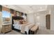 A cozy main bedroom features tray ceilings, neutral tones, and a large bed with decorative pillows and bench seating at 1739 Goodwin, Hampton, GA 30228