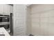 A walk-in pantry features wire shelving for optimal storage, adjacent to stainless steel appliances at 1739 Goodwin, Hampton, GA 30228