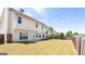 Expansive backyard featuring a lush green lawn, enclosed by a wooden fence for added privacy at 2805 Topaz Rd, Riverdale, GA 30296