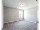 This bedroom has neutral walls, plush carpeting, and a window with natural light at 2805 Topaz Rd, Riverdale, GA 30296