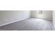 Bedroom showing neutral walls, plush carpeting, and a window with natural light at 2805 Topaz Rd, Riverdale, GA 30296