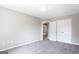 Bedroom with plush carpeting, neutral walls, closet, and a view into another room at 2805 Topaz Rd, Riverdale, GA 30296