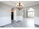 Dining area boasts elegant lighting and trim, leading to an archway into the living room at 2805 Topaz Rd, Riverdale, GA 30296