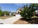 Charming two-story home with a stone veneer and a well-manicured front yard under a clear blue sky at 2805 Topaz Rd, Riverdale, GA 30296