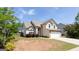 Inviting two-story home with a blend of stucco and stone, accented by a well-maintained lawn at 2805 Topaz Rd, Riverdale, GA 30296